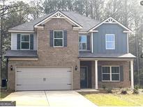 Charming two-story home with brick facade, well-manicured lawn, and attached two-car garage at 305 Wheeler Creek Ln # 21, Mcdonough, GA 30252