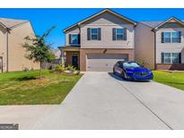 Charming two-story home with a brick-accented front and a well-manicured lawn with a blue car parked in the driveway at 1597 Culpepper Ln, Mcdonough, GA 30253