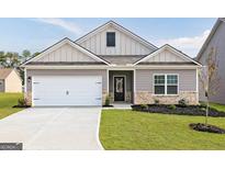 Charming single-Gathering home featuring a two-car garage and professionally landscaped front yard at 289 Limestone Circle, Conyers, GA 30013