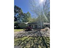 Charming exterior featuring a stone accent entry and mature landscaping with a circular driveway at 2285 Rock Springs Rd, Buford, GA 30519