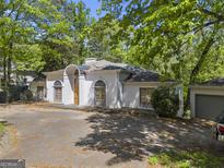 White home featuring an arch over entry and a driveway surrounded by mature trees at 3985 Randall Mill Nw Rd, Atlanta, GA 30327