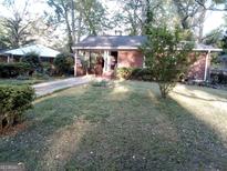 Charming brick home with a well-maintained front yard, offering curb appeal and a welcoming entrance at 637 Ferris Sw St, Atlanta, GA 30310