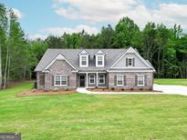Beautiful one-story brick home with a manicured lawn and a welcoming entrance at 2113 Ella Springs Dr, Covington, GA 30014