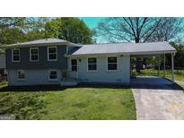 Charming two-story home with a covered carport and freshly painted exterior, ready for new owners at 2571 Stanford Dr, Ellenwood, GA 30294