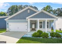 Charming blue home with white trim, a welcoming porch, and a well-manicured lawn at 790 Riverwood Pass, Dallas, GA 30157