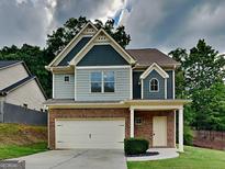 Charming two-story home featuring brick and siding exterior, complemented by a well-manicured lawn and attached garage at 1162 Ida Woods Ln # 23, Lawrenceville, GA 30045
