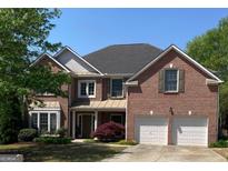Charming two-story brick home with manicured landscaping and a two-car garage at 514 Augusta Dr, Canton, GA 30115