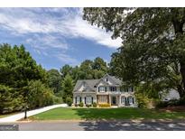 Charming two-story home with a manicured lawn and well-maintained landscaping, creating a welcoming curb appeal at 6205 Collingham Trce, Cumming, GA 30040