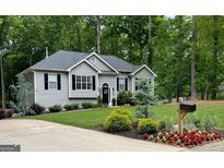Charming single-story home with well-maintained landscaping and a welcoming front entrance at 5930 Shannon Dr, Cumming, GA 30040