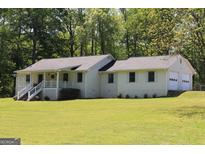 Charming one-story home with a large yard and inviting front porch at 288 Trickum Creek Rd, Tyrone, GA 30290