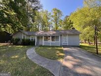 Charming single-story home featuring a well-maintained front yard and covered porch at 9022 Homewood Dr, Riverdale, GA 30274