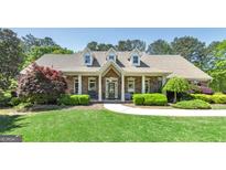 Charming brick home with a manicured lawn and inviting front porch at 330 Noah Pl, Mcdonough, GA 30252