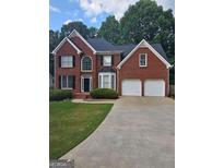 Charming brick two-story home with a well-maintained lawn and a two-car garage at 5114 Verbena Nw Dr, Acworth, GA 30102