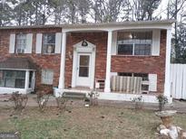 Traditional brick home featuring a covered front porch and shuttered windows at 1025 Lynwood Pl, Forest Park, GA 30297