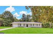 Charming single-story home featuring a large, well-manicured front lawn and a classic exterior at 4140 Pierce Rd, South Fulton, GA 30349