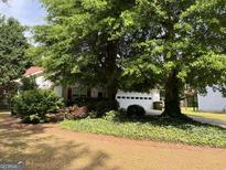 Charming single-story home with mature trees and landscaping, offering a serene and private setting at 3041 Regal Dr, Mcdonough, GA 30253