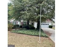 Quaint single story home featuring mature trees and a two car garage at 3041 Regal Dr, Mcdonough, GA 30253