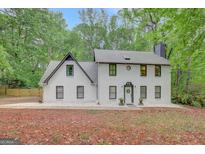 Stunning two-story home featuring a white brick exterior and a beautifully landscaped front yard at 180 Bentley Way, Fayetteville, GA 30214