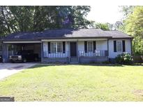 Charming single-story home featuring a carport, front porch, and a well-manicured lawn at 4793 Davenport Nw Trce, Acworth, GA 30101