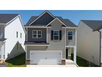 Charming two-story home featuring a two-car garage and neutral siding at 12040 Conrad Cir, Hampton, GA 30228
