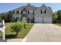 Traditional two-story home with a well-maintained lawn and a two-car garage at 1028 Field View Dr, Mcdonough, GA 30253