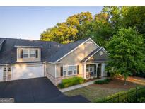 Charming home with a well manicured lawn, a two-car garage, and beautiful landscaping at 2623 Grapevine Cir # 602, Cumming, GA 30041