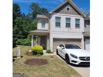 Charming brick townhome with a well-manicured lawn and attached garage at 3168 Spicy Cedar Ln, Lithonia, GA 30038