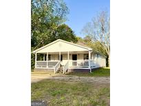 Charming ranch home features a covered front porch with white railings and steps at 11755 Highway 36, Covington, GA 30014