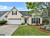 Charming single-Gathering home with a well-maintained front yard and attached two-car garage at 121 St Albans Way, Peachtree City, GA 30269