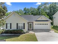 Charming single-Gathering home featuring manicured lawn, attached garage, and a welcoming facade at 462 Chase Marion Way, Mcdonough, GA 30253