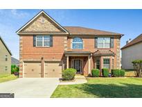 Charming two-story brick home with attached two-car garage and well-manicured lawn at 532 Pelham Pl, Mcdonough, GA 30253