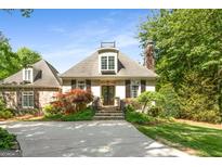 Charming home featuring stone accents, dormer window, meticulously landscaped front yard and inviting walkway at 204 Clear Springs Ln, Peachtree City, GA 30269