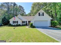 Charming one-story home featuring a well-manicured lawn and a two-car garage at 4735 Rabbit Farm Rd, Loganville, GA 30052