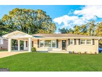 Charming one-story home with well-maintained lawn and covered carport at 2818 Lynda Pl, Decatur, GA 30032