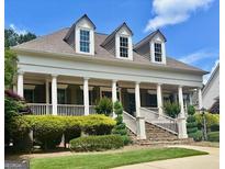 Charming traditional home featuring a welcoming front porch, well-manicured lawn, and classic architectural details at 100 Trotters Rdg, Fayetteville, GA 30215