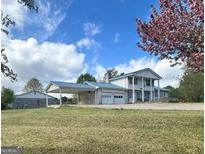 Inviting two-story home with a steel roof, covered parking, and charming curb appeal at 732 Sandhill Shady Grove Rd, Carrollton, GA 30116