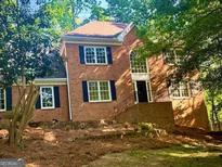 Charming brick two-story home with black shutters, large windows, and an inviting entrance at 535 Emerald Pkwy, Sugar Hill, GA 30518