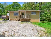 Charming single-story home featuring a classic front porch and gravel driveway at 6249 Cooper St, Douglasville, GA 30134