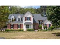 Charming two-story home with red shutters, brick accents and meticulously landscaped front yard at 250 Clearview Cir, Mcdonough, GA 30253