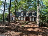 Charming brick home featuring traditional shutters and mature trees for shade at 110 The Farm Rd, Mcdonough, GA 30252