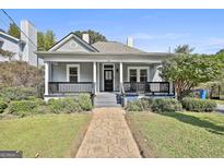 Charming home with a covered front porch, landscaped yard, and inviting walkway at 1449 Wadley Ave, East Point, GA 30344