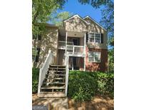 Inviting two-story townhouse with brick accents and wooden stairs leading to the front door at 446 Teal Ct, Roswell, GA 30076