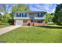 Charming brick home with a well-manicured lawn and a two-car garage, perfect for Gathering living at 130 Belmont Farms Dr, Ellenwood, GA 30294