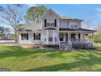 Charming two-story home with a well-manicured lawn and inviting front porch at 701 Monticello Ln, Mcdonough, GA 30253