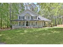 Charming two-story home boasts a full front porch and mature landscaping at 110 Greenridge Ct, Fayetteville, GA 30215