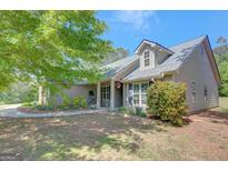 Charming home featuring manicured landscaping and traditional architectural details under a clear blue sky at 103 Fuller Ct, Grantville, GA 30220