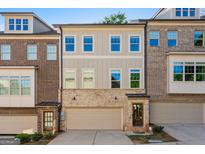 Beautiful townhome with light grey painted wood and brick exterior and garage at 1106 Bakary Ct, Decatur, GA 30032