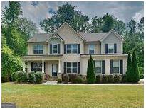 Charming two-story home with landscaped yard and inviting curb appeal at 147 Tara Blvd, Loganville, GA 30052