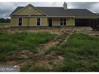 Unfinished exterior view of a single-story home featuring a chimney, attached garage, and a neutral color scheme at 3219 Broadnax Mill Rd # 5, Loganville, GA 30052