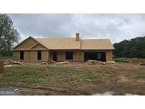 Unfinished exterior of a home with a roof and chimney at 3219 Broadnax Mill Rd # 5, Loganville, GA 30052